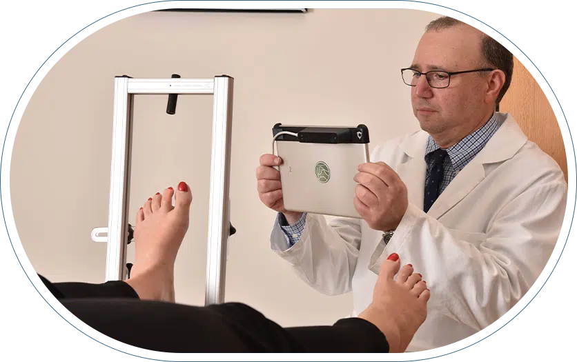 Orthopedic specialist taking a picture of his patient's feet with a tablet.